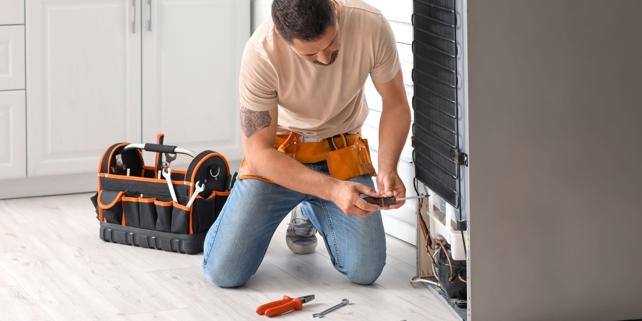 a technician fixing refrigerator